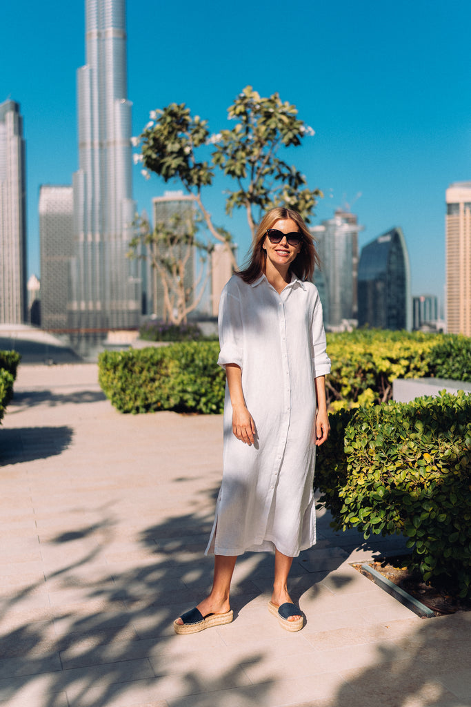 Woman standing in a white dress in Downtown Dubai.